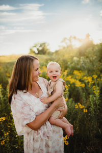 mom and baby in flowering meadow